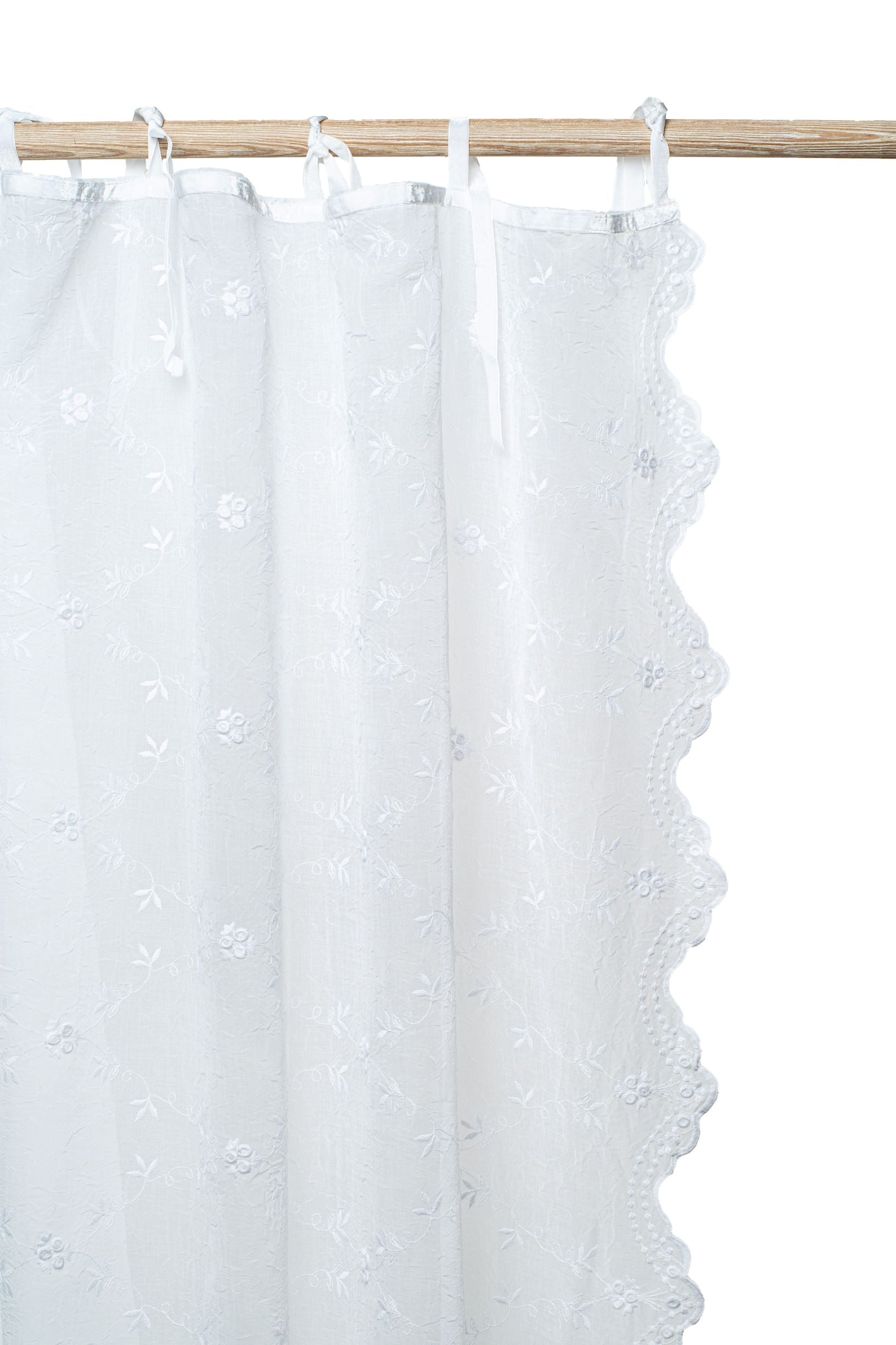Off-white-Victoria-voile-curtain-with-scalloped-edges-adds-a-touch-of-elegance-to-a-living-room.
