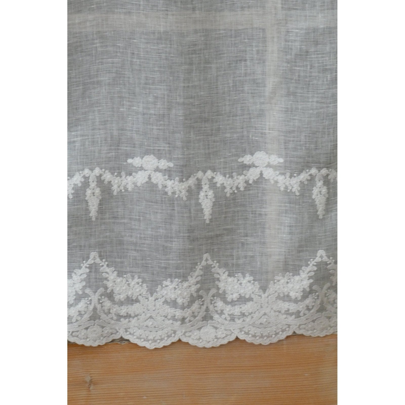 Embroidered linen short curtain adds a touch of rustic elegance to your kitchen window.